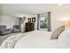 Bright bedroom with many windows featuring soft carpet, a plush bed, and elegant decor at 6712 S Leyden Ct, Centennial, CO 80112