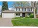Charming two-story home with a well-manicured lawn, white exterior, black shutters, and an attached two-car garage at 6712 S Leyden Ct, Centennial, CO 80112