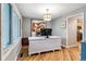 Bright home office with hardwood floors, large windows, and a stylish white desk at 6712 S Leyden Ct, Centennial, CO 80112