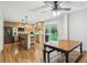 Updated kitchen featuring stainless steel appliances, a center island with bar stools, and hardwood floors at 6712 S Leyden Ct, Centennial, CO 80112
