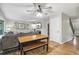 Bright living room with hardwood floors, a ceiling fan, staircase, and a wooden table set at 6712 S Leyden Ct, Centennial, CO 80112