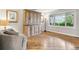Bright living room featuring hardwood floors, built-in storage, and a large window at 6712 S Leyden Ct, Centennial, CO 80112