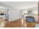 Bright and inviting living room with hardwood floors, stairs to the second level, and comfortable seating at 6712 S Leyden Ct, Centennial, CO 80112