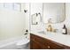 Bathroom featuring warm wood vanity, bright mirror, and white subway tile in the shower at 333 Quitman St, Denver, CO 80219