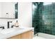 Bathroom features green tile shower, wood vanity, and modern fixtures at 333 Quitman St, Denver, CO 80219