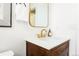 Bathroom featuring warm wood vanity, bright mirror, and white quartz countertop at 333 Quitman St, Denver, CO 80219