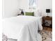 Well-lit bedroom with white bedding, wood furniture, and stylish rug at 333 Quitman St, Denver, CO 80219