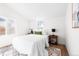 Bright bedroom with white bedding, wood furniture, and stylish rug at 333 Quitman St, Denver, CO 80219