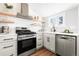 Modern kitchen featuring stainless steel appliances and white tile backsplash at 333 Quitman St, Denver, CO 80219