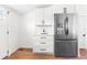 Bright kitchen with white cabinets, stainless steel refrigerator and wood floors at 333 Quitman St, Denver, CO 80219