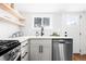 Kitchen with white cabinets, stainless steel appliances, and view from the window at 333 Quitman St, Denver, CO 80219