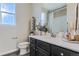 Clean bathroom with dark vanity, quartz countertop, and shower at 19078 E 94Th Pl, Commerce City, CO 80022