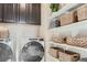 Laundry room with washer, dryer, and ample storage shelving at 19078 E 94Th Pl, Commerce City, CO 80022