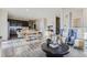 Living room with gray armchairs, a sofa and a coffee table at 19078 E 94Th Pl, Commerce City, CO 80022