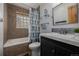 Well-lit bathroom featuring a shower-tub combo and modern vanity at 54 Zaza Ln, Evergreen, CO 80439
