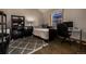 Cozy bedroom with hardwood floors, a large window, and a comfortable workspace at 54 Zaza Ln, Evergreen, CO 80439