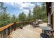 Expansive deck with mountain views, complete with outdoor dining and grilling areas at 54 Zaza Ln, Evergreen, CO 80439