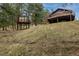 Unique home design featuring a main house and additional cabin on an inclined lot at 54 Zaza Ln, Evergreen, CO 80439