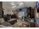 Open-concept living room featuring a stone fireplace, vaulted ceiling and a seamless flow to the kitchen at 54 Zaza Ln, Evergreen, CO 80439