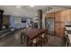 Spacious living area with a stone fireplace, modern kitchen appliances, and hardwood flooring at 54 Zaza Ln, Evergreen, CO 80439