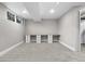Spacious basement featuring neutral carpet, large window, and built-in desk with white cabinets at 6508 E Euclid Pl, Centennial, CO 80111