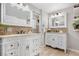 Elegant bathroom featuring dual vanities with stylish mirrors and tile accents at 6508 E Euclid Pl, Centennial, CO 80111