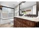 Bathroom with double sink vanity, granite counters, and shower-tub combination at 6508 E Euclid Pl, Centennial, CO 80111