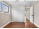 Bright bedroom featuring wood floors, white trim, and sliding closet doors at 6508 E Euclid Pl, Centennial, CO 80111