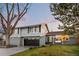 Charming two-story home with neutral gray paint, a brick-lined garage, and a cozy porch swing at 6508 E Euclid Pl, Centennial, CO 80111