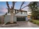 View of home featuring a two-car garage, neutral gray paint and a mature tree in the front yard at 6508 E Euclid Pl, Centennial, CO 80111