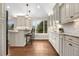 Kitchen with white cabinetry, bar seating, granite countertops and hardwood flooring at 6508 E Euclid Pl, Centennial, CO 80111