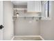 Bright laundry room with tile flooring, built-in shelving, a window and white cabinetry at 6508 E Euclid Pl, Centennial, CO 80111
