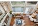 Cozy living room with a stone fireplace, large windows, and access to the outdoor patio at 6508 E Euclid Pl, Centennial, CO 80111