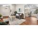 Inviting living room with a neutral color palette, opening to a kitchen area with bar seating at 6508 E Euclid Pl, Centennial, CO 80111