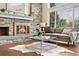 Inviting living room featuring a fireplace, large windows, and comfortable seating area at 6508 E Euclid Pl, Centennial, CO 80111