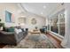 Bright living room featuring vaulted ceilings, a large window, and stylish furnishings at 6508 E Euclid Pl, Centennial, CO 80111