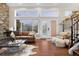 Bright living room with hardwood floors, large windows, a comfortable leather sofa, and stylish decor at 6508 E Euclid Pl, Centennial, CO 80111