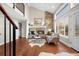 Living room with a stone fireplace, large windows, and wood flooring at 6508 E Euclid Pl, Centennial, CO 80111