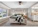 Cozy bedroom with natural light, a decorative bed frame, and a glimpse into the en-suite bathroom at 6508 E Euclid Pl, Centennial, CO 80111