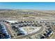 Aerial shot of a neighborhood with modern homes surrounding a central park area in a picturesque setting at 14106 Red Cosmos St, Parker, CO 80134