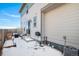 Cozy backyard patio with outdoor seating, concrete steps, and a charming exterior view on a winter's day at 14106 Red Cosmos St, Parker, CO 80134