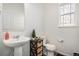 Clean bathroom with pedestal sink and stylish stained glass window at 14106 Red Cosmos St, Parker, CO 80134