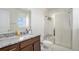 Well-lit bathroom featuring a granite vanity, walk-in shower with a seat, and modern fixtures at 14106 Red Cosmos St, Parker, CO 80134