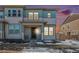 Two-story townhome with light blue and white siding, and a covered front porch at 14106 Red Cosmos St, Parker, CO 80134