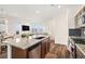 Bright kitchen with a granite island, stainless steel appliances, and open layout to the living room at 14106 Red Cosmos St, Parker, CO 80134