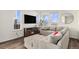 Living room with L-shaped sectional sofa, fireplace, and large windows at 14106 Red Cosmos St, Parker, CO 80134