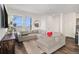 Spacious living room with L-shaped sectional sofa and large windows at 14106 Red Cosmos St, Parker, CO 80134