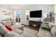 Cozy living room with fireplace, dining area, and sliding door to an outdoor space at 14106 Red Cosmos St, Parker, CO 80134