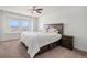 Comfortable bedroom with a large bed, ceiling fan, and window seat offering scenic views at 14106 Red Cosmos St, Parker, CO 80134