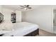 Neutral primary bedroom with a ceiling fan, walk-in closet, and en-suite bathroom at 14106 Red Cosmos St, Parker, CO 80134